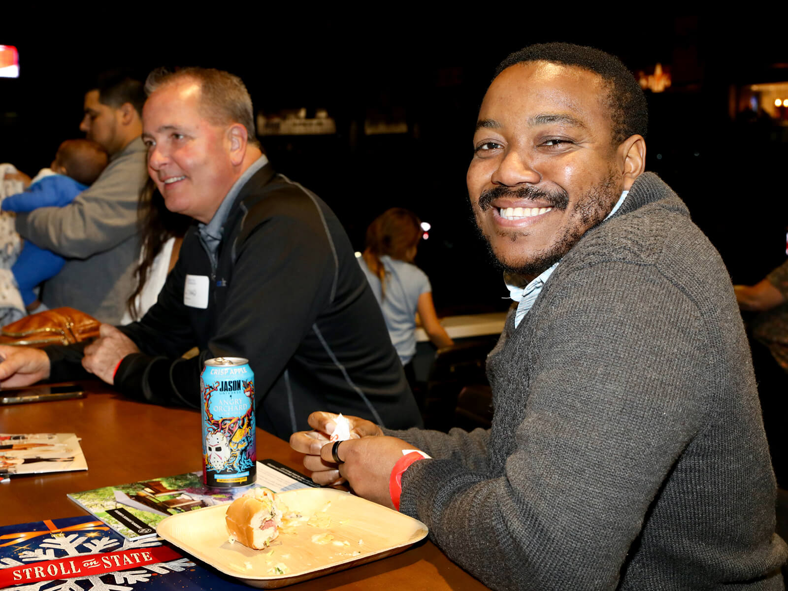 A man eating a sandwich at a Rockford mixer