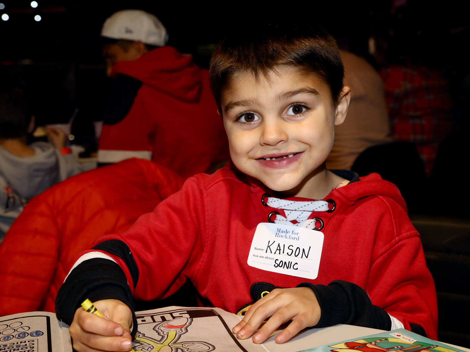 A child coloring at a Made for Rockford mixer