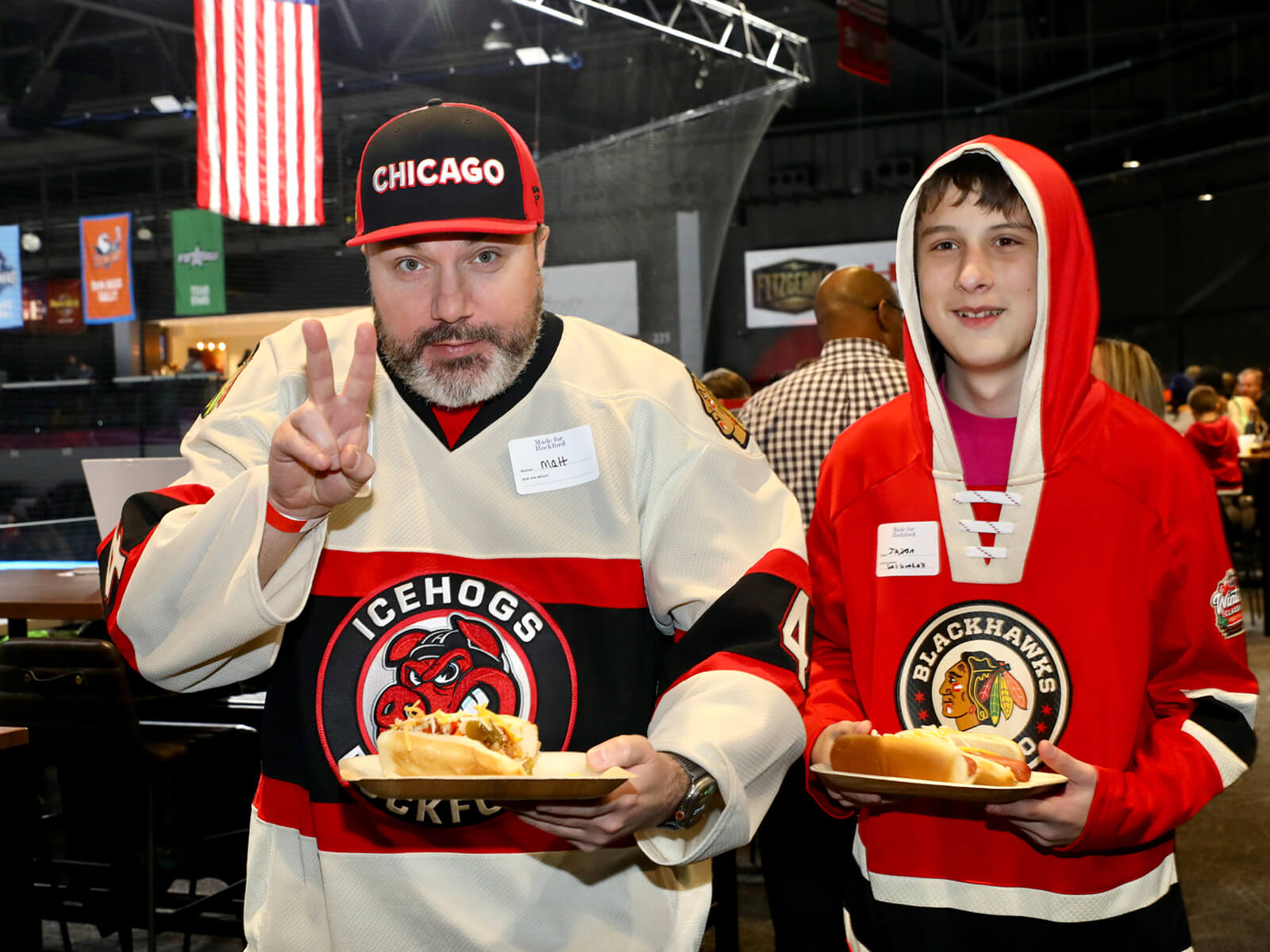 IceHogs fans carrying hot dogs