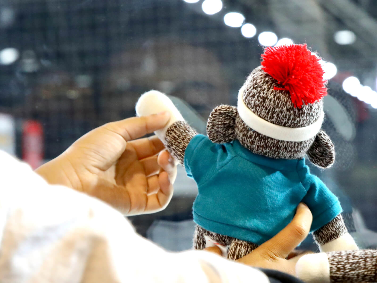 A sock monkey waving inside the BMO Center