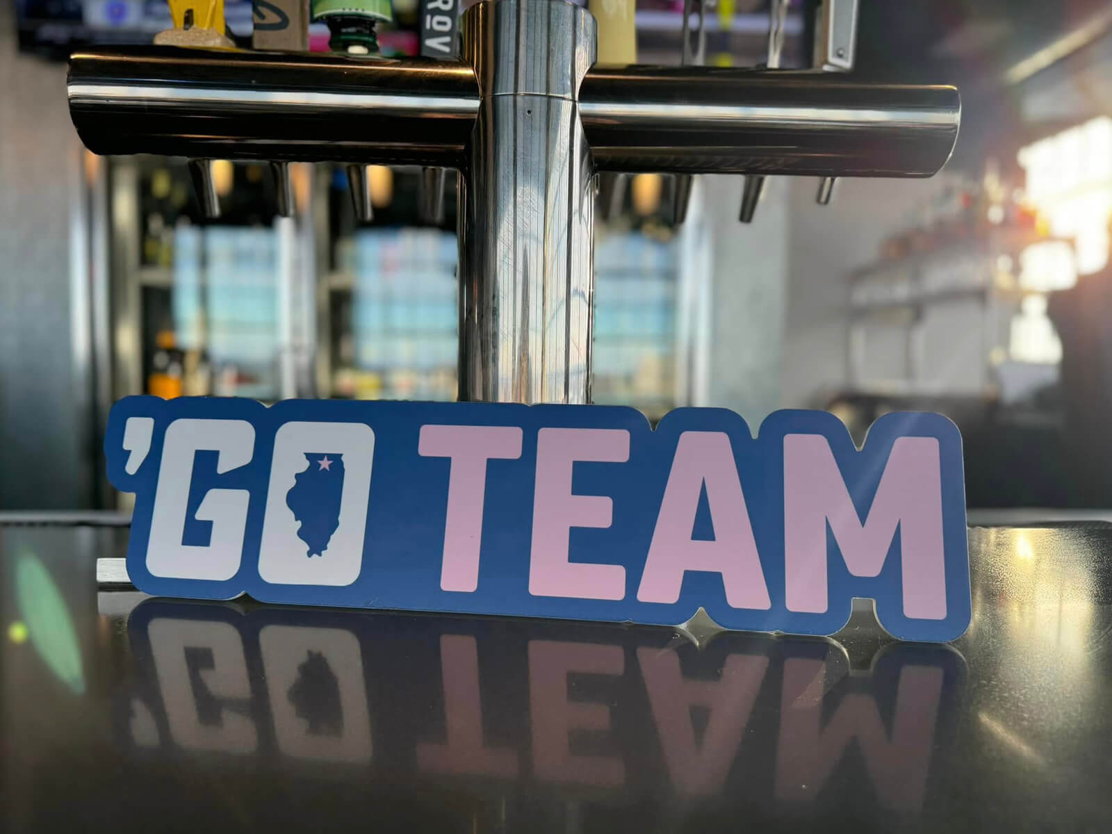 A Made for Rockford 'Go Team sticker sitting on the bar at Embassy Suites