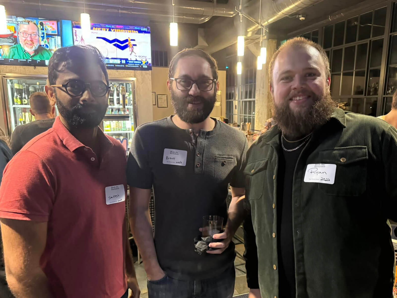 Three Rockford residents standing in Embassy Suites during a Made for Rockford mixer