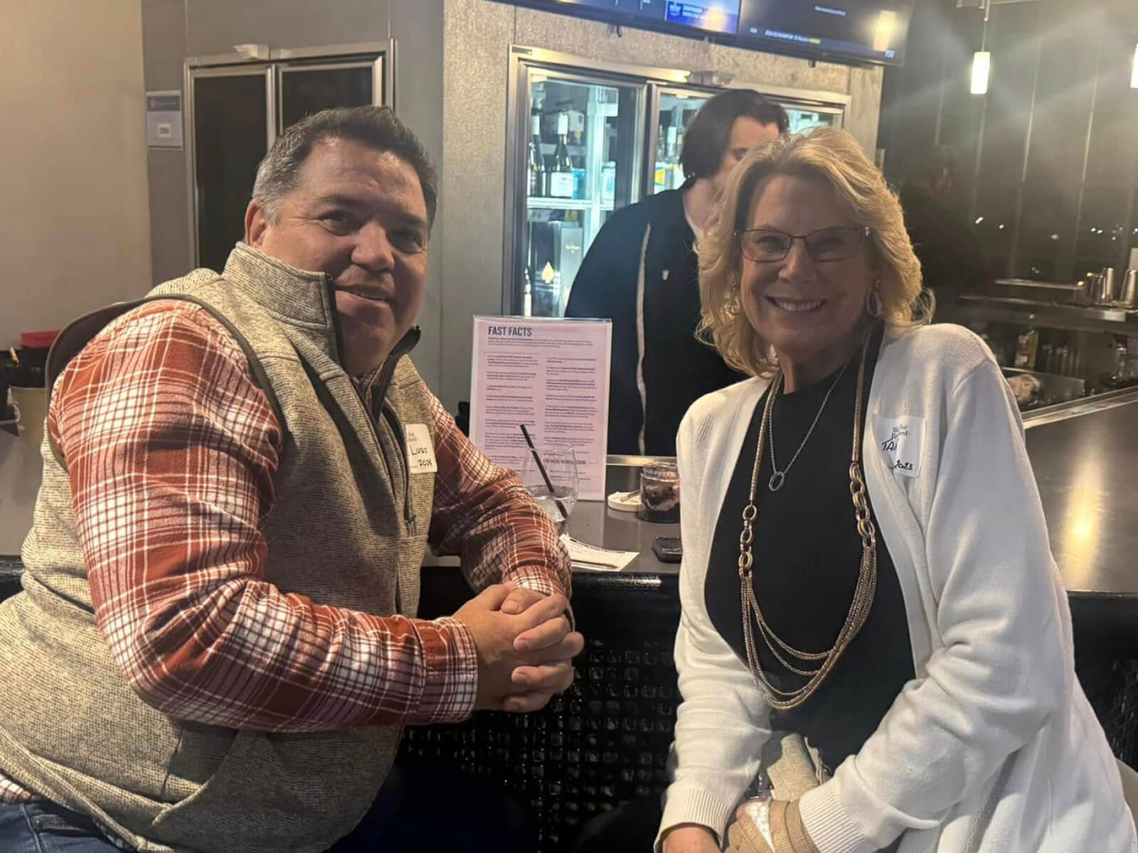 Two Rockford residents sitting at the bar during a new resident mixer at Embassy Suites