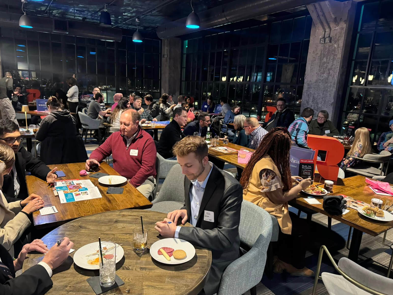Rockford residents eating at tables at Embassy Suites during a Made for Rockford mixer 