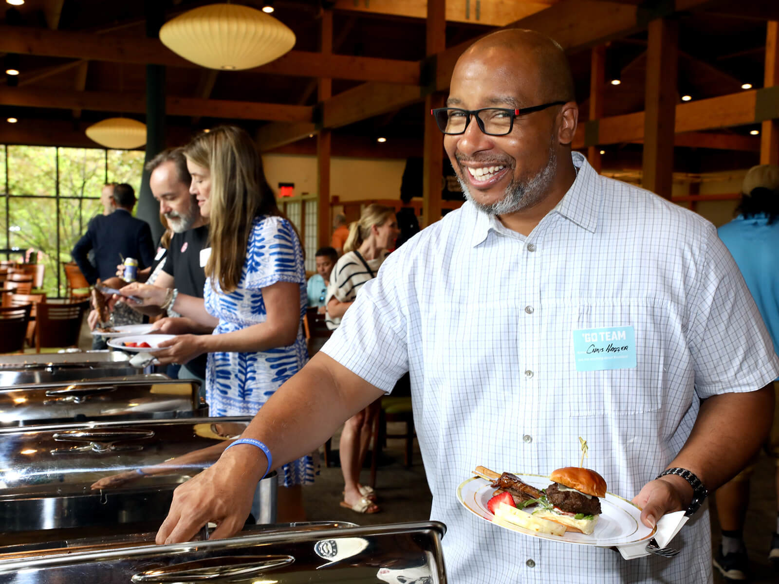 A man getting food at a Rockford new resident mixer