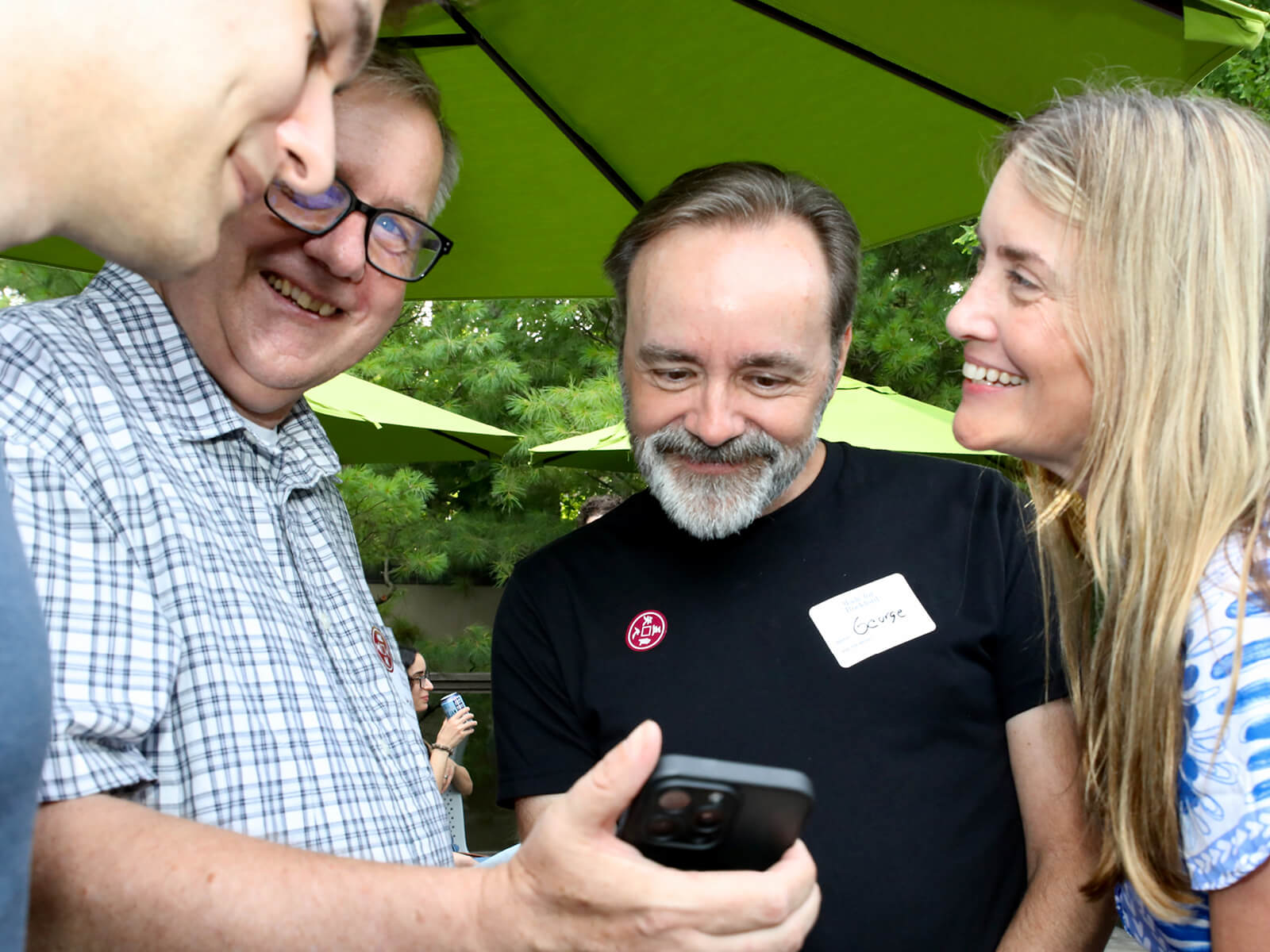 A man shows other Rockford residents his phone at a Made For Rockford mixer