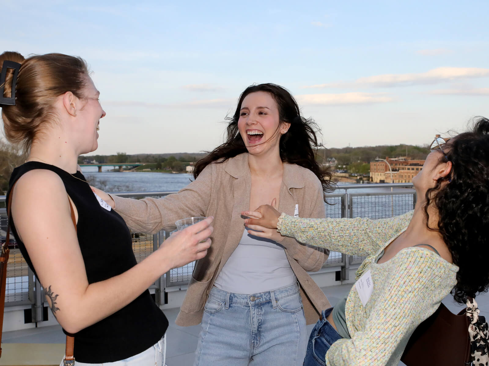 Friends laugh together at Rockford new resident mixer
