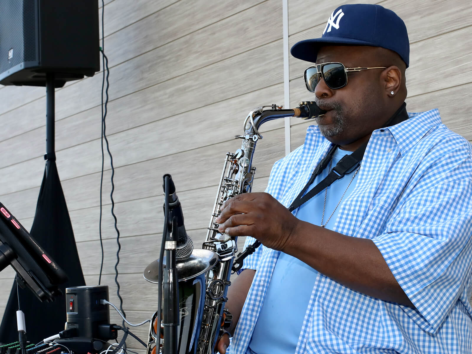 A man playing saxophone at a Rockford new resident mixer