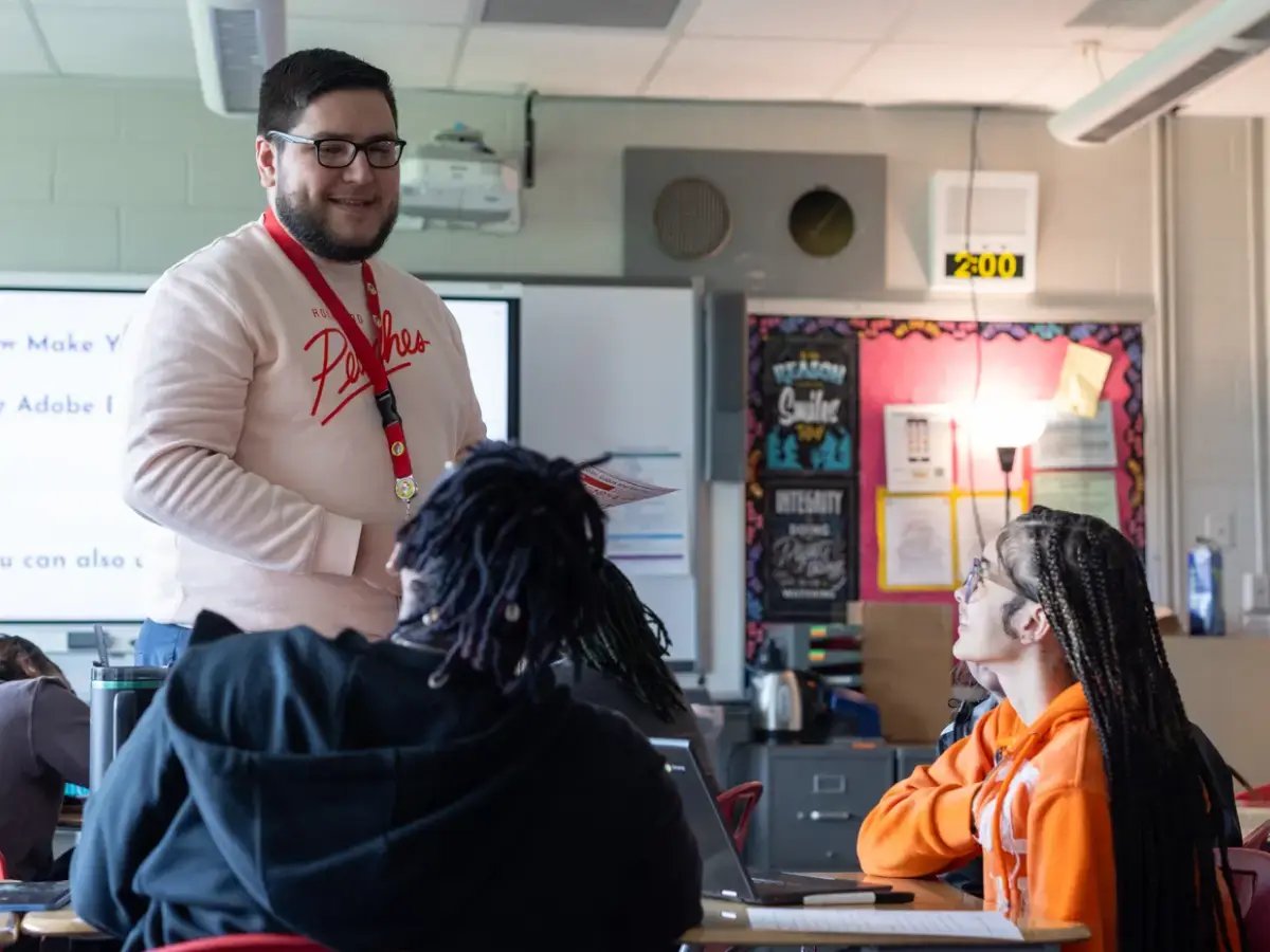 Teacher talking with two of his students
