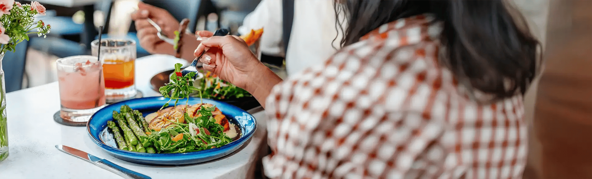 Woman eating at a dinner table